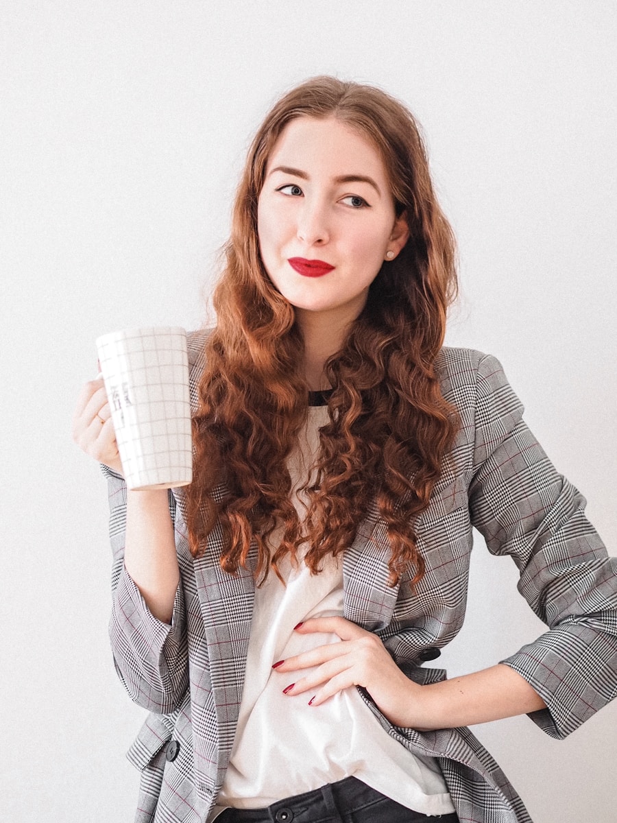 woman in gray cardigan holding white ceramic mug with a traditional career path