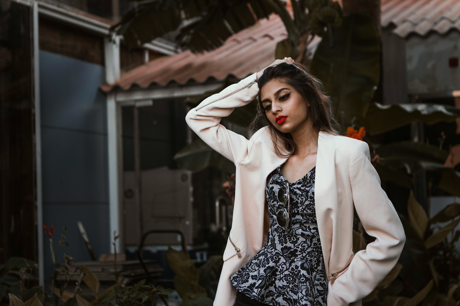 woman in white blazer standing and smiling symbolizing how to let an employee go